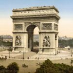 Arc de Triomphe at Place de l'Étoile with horse-drawn carriages and pedestrians